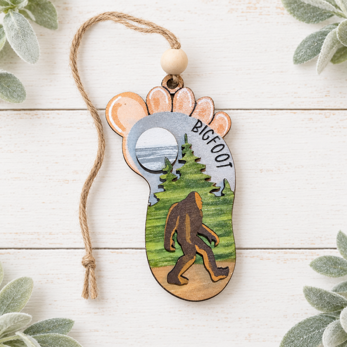 Hand-painted Bigfoot footprint ornament with forest and moon design