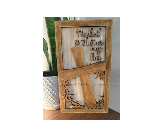 Wooden sign “He died so that we may live”