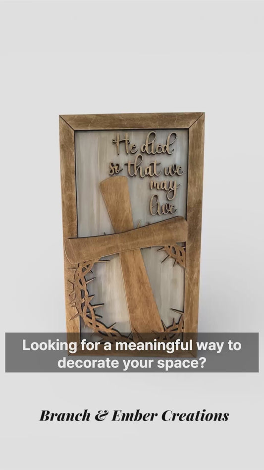 Wooden sign “He died so that we may live”