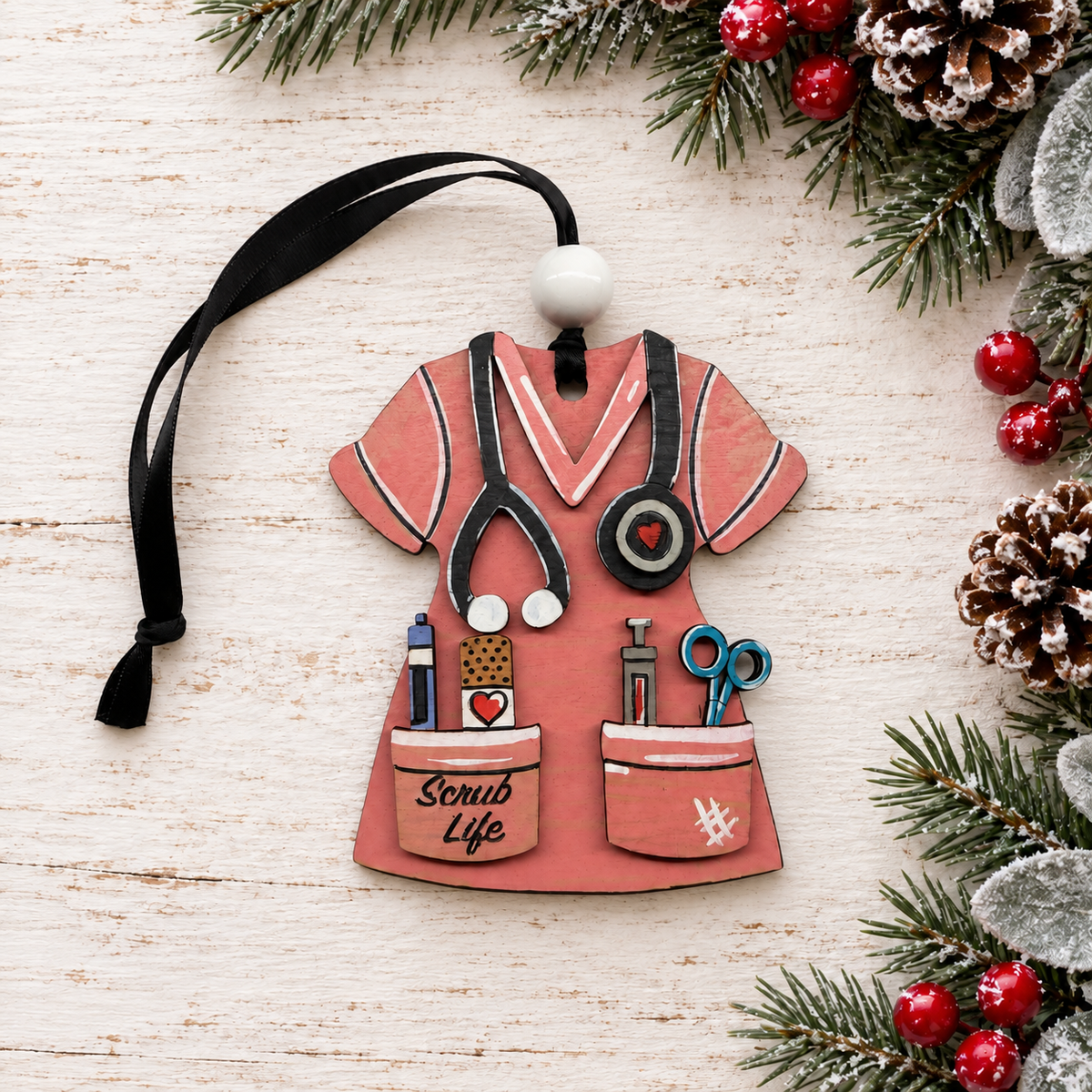 Scrub Life nurse ornament on whitewashed wood with evergreen branches and berries